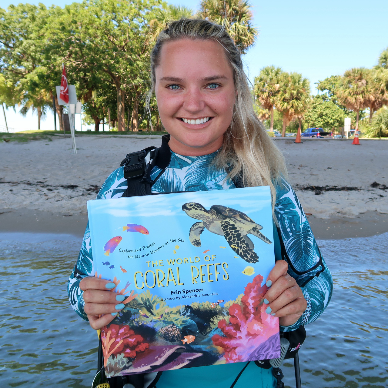Holding my first children's book, The World of Coral Reefs, which shares the biology, ecology, and conservation of coral reefs with children aged 7-10. PC: Drew Butkowski