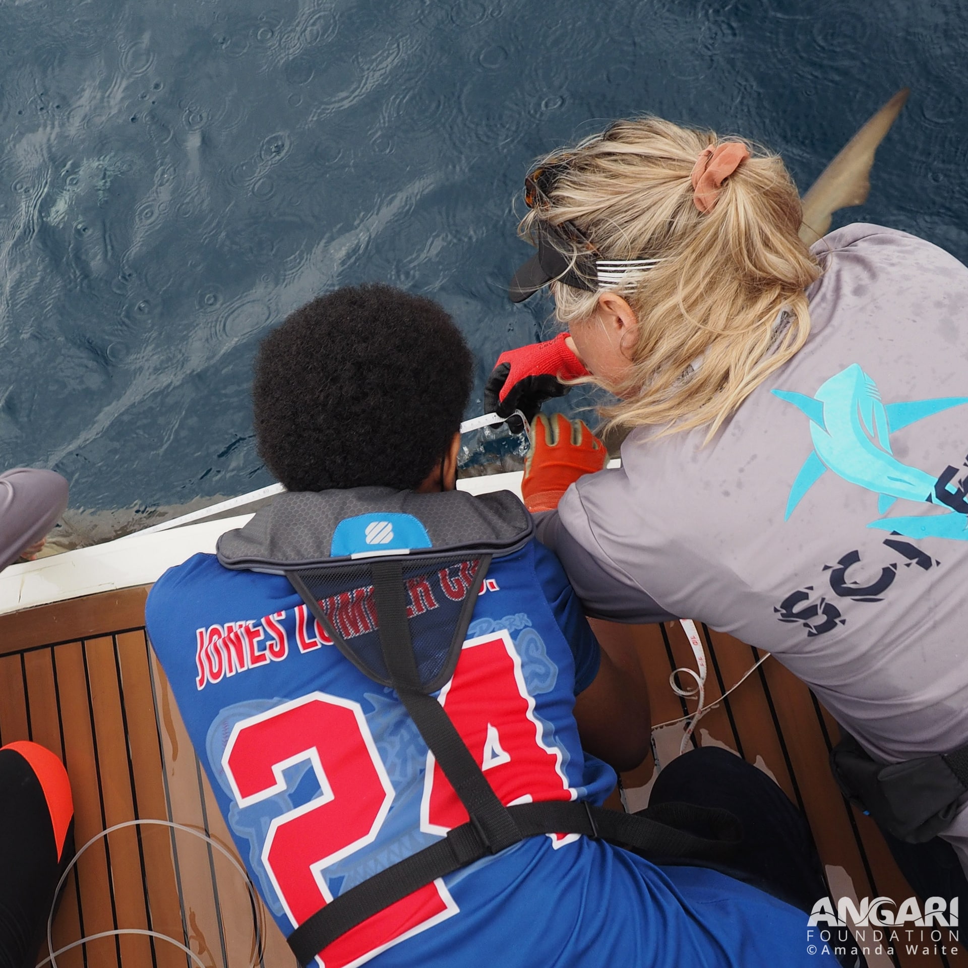 Helping a student measure a lemon shark on a Coastal Ocean Explorers: Sharks expedition. PC: Amanda Waite