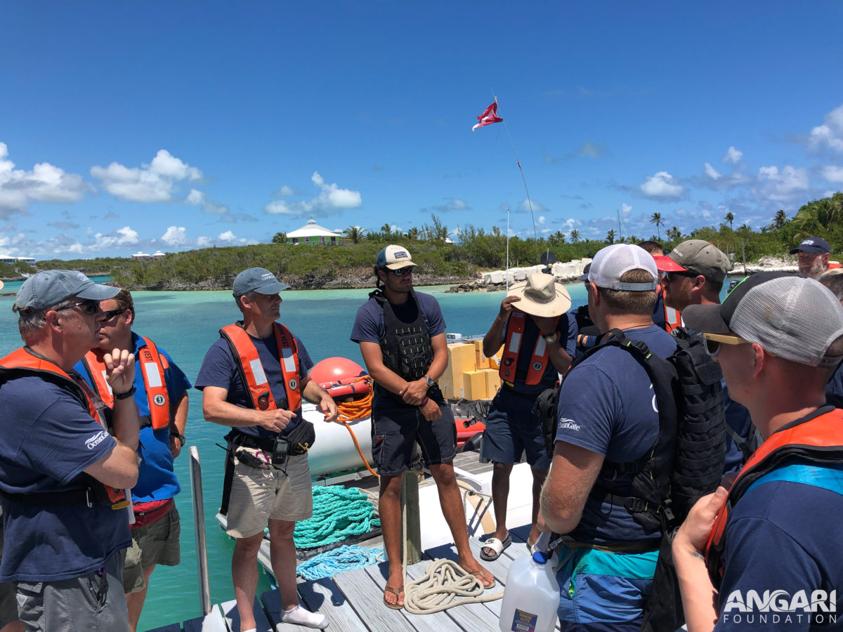 EXP 24: OceanGate Crew, R/V ANGARI Crew, and Mission Specialists have a meeting before setting out on the mission. PC: Angela Rosenberg