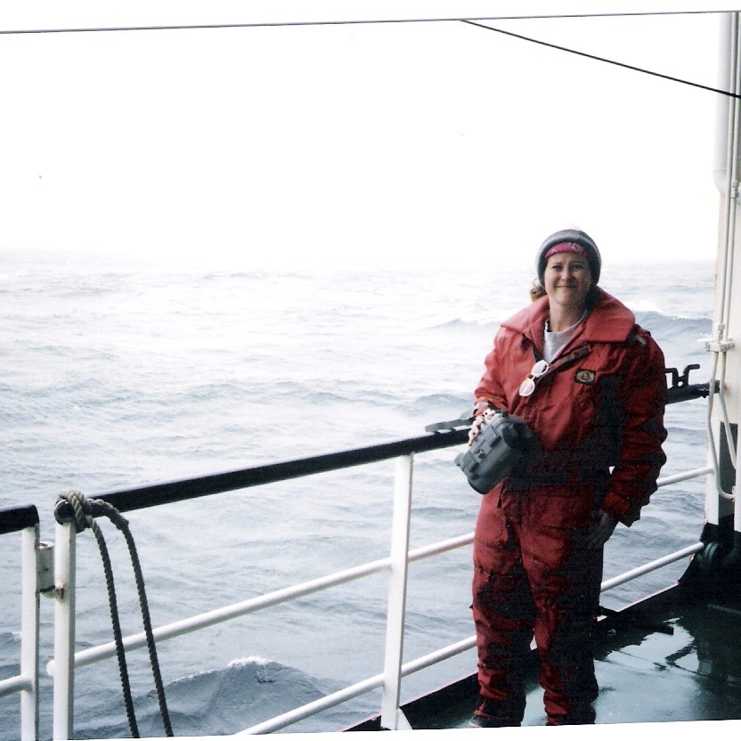 On deck of R/V Nathaniel Palmer filming visiting whales and penguins during an expedition to the Southern Ocean to study deep-sea fishes.