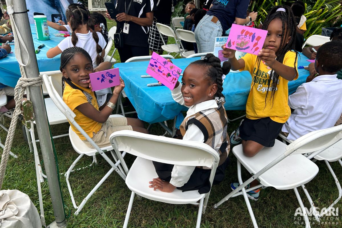 Students from Glades Academy Charter School proudly hold up their decorated Lagoon Drift cards.