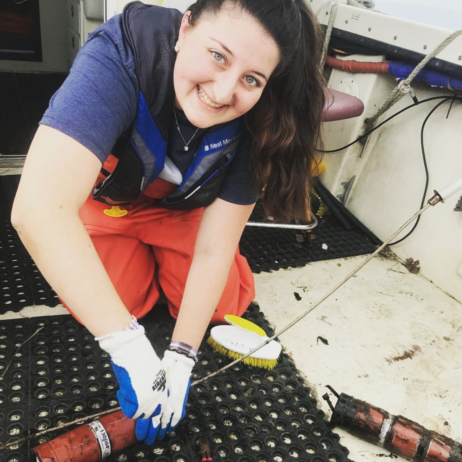 Smiling as I download acoustic receiver data as part of my undergraduate research in New Jersey, supporting coastal fish movement and tracking studies.