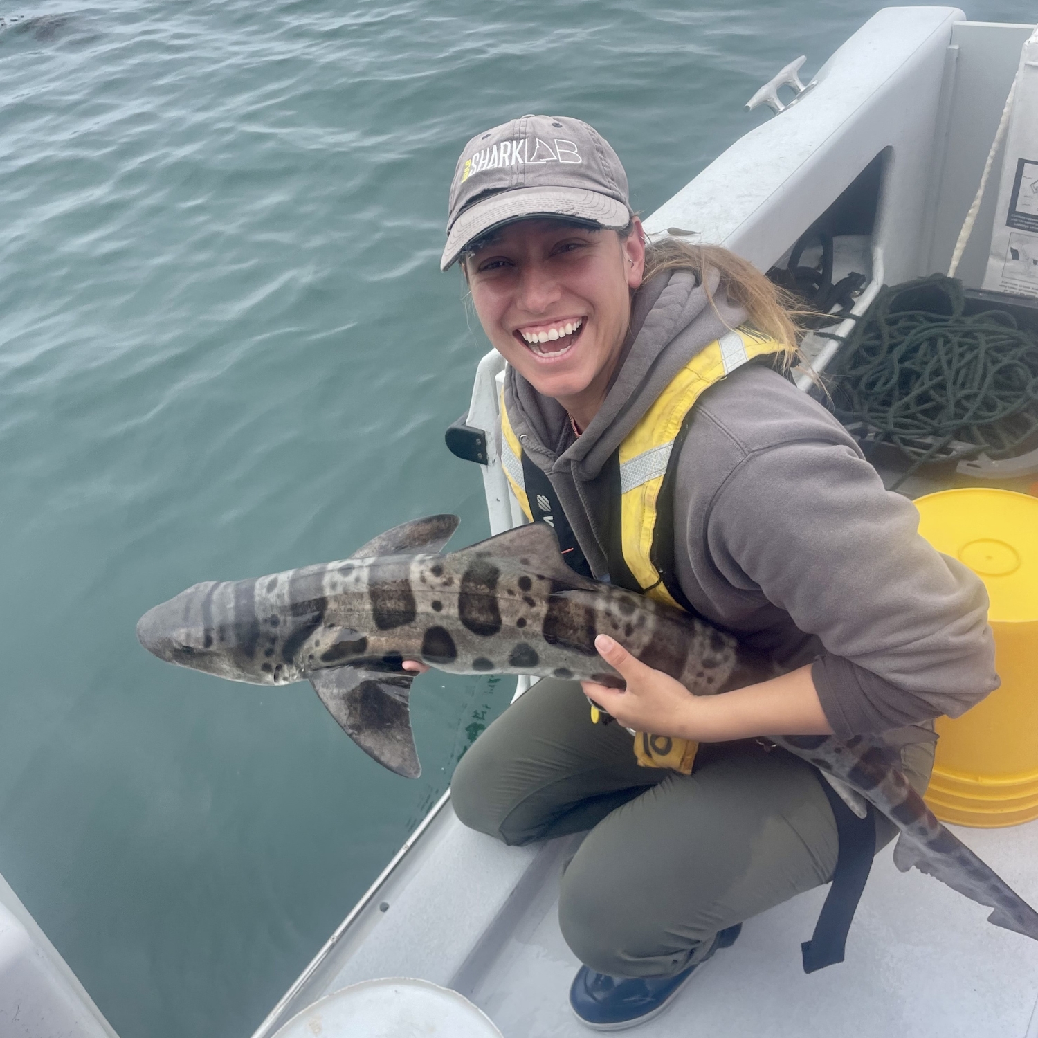 I am all smiles as I release this leopard shark after tagging it.
